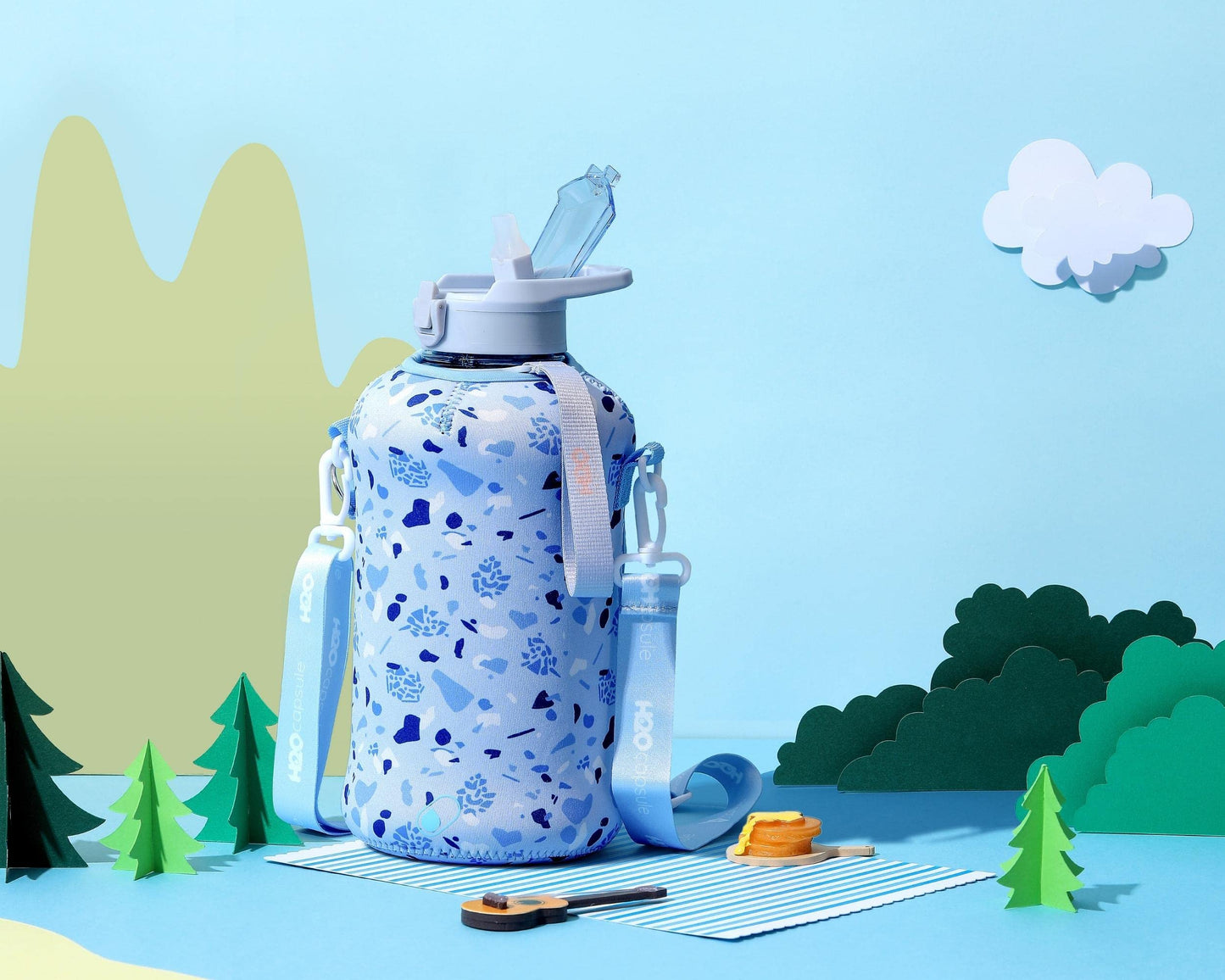 H2O Capsule 2.2L Half Gallon Water Bottle with Storage Sleeve and straw lid– BPA Free Large Water Bottle/2.2 Liter (74 Ounce) Big Sports Bottle Jug with Handle (Blue Pebbles)