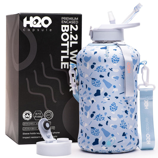 H2O Capsule 2.2L Half Gallon Water Bottle with Storage Sleeve and straw lid– BPA Free Large Water Bottle/2.2 Liter (74 Ounce) Big Sports Bottle Jug with Handle (Blue Pebbles)