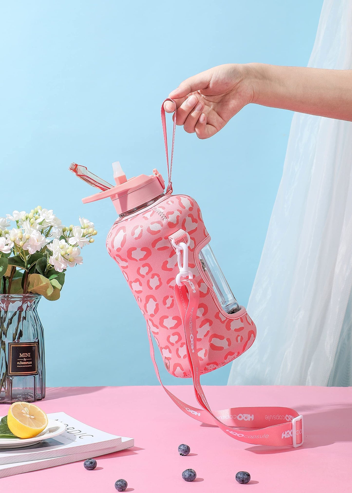 H2O Capsule 2.2L Half Gallon Water Bottle with Storage Sleeve and Covered Straw Lid – BPA Free Large Reusable Drink Container with Handle - Big Sports Jug, 2.2 Liter (74 Ounce) Pink Leopard
